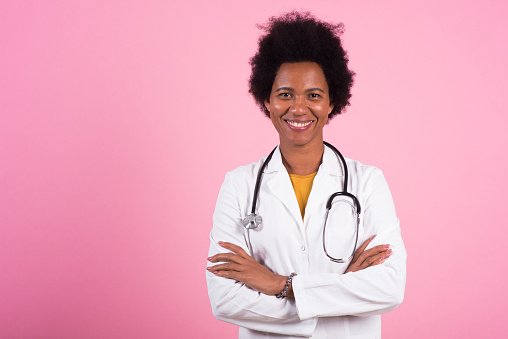 A doctor in a white coat with arms crossed