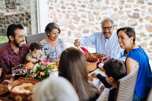 A family sharing a meal outdoors