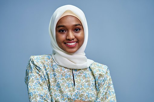 A doctor wearing a hijab, smiling