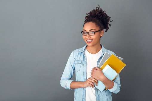 A doctor in glasses holding folders