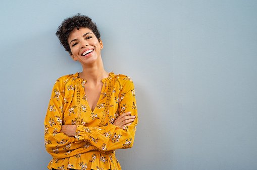 A doctor in a yellow top, smiling