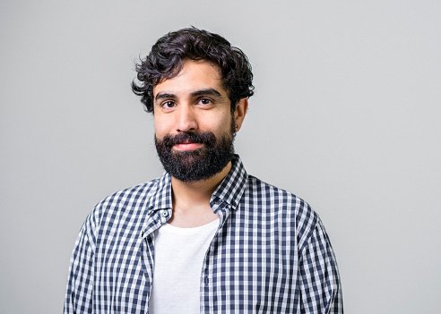 A bearded doctor in a checked shirt