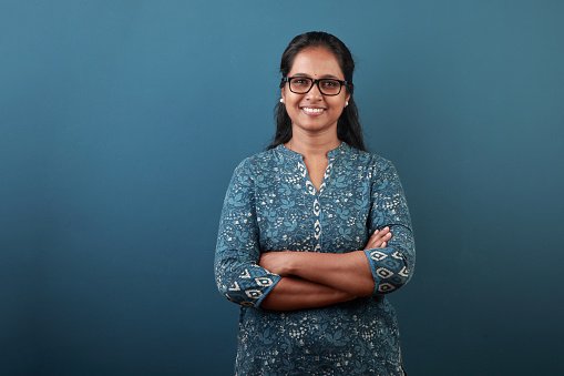 A doctor in a teal top, smiling
