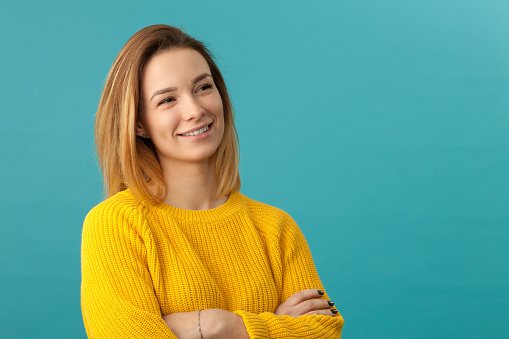 A doctor in a yellow jumper, smiling
